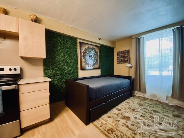 bedroom with light wood-type flooring