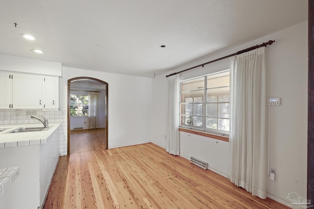 interior space with light hardwood / wood-style floors, sink, and radiator