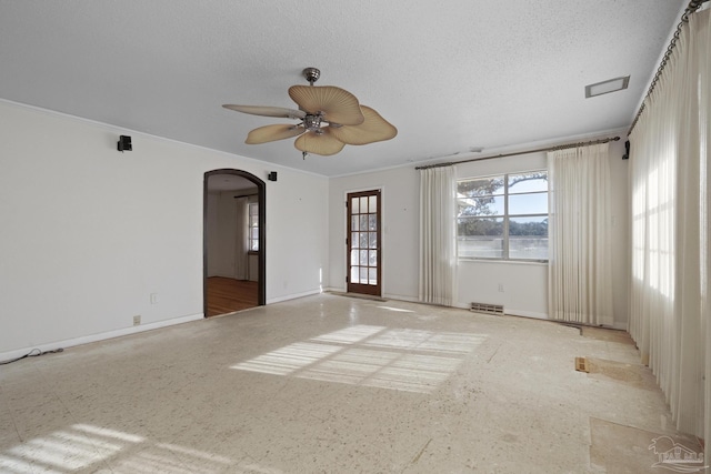 unfurnished room featuring ceiling fan and a textured ceiling