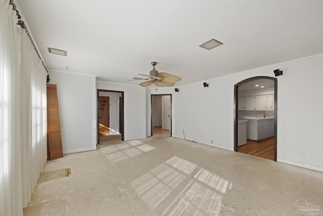 unfurnished bedroom with connected bathroom, ceiling fan, ornamental molding, and sink