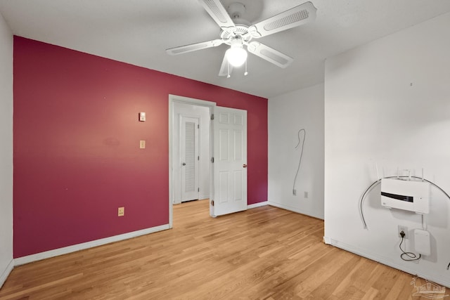 interior space featuring light wood-type flooring, heating unit, and ceiling fan