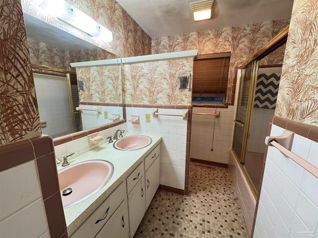 bathroom featuring vanity, enclosed tub / shower combo, and tile walls