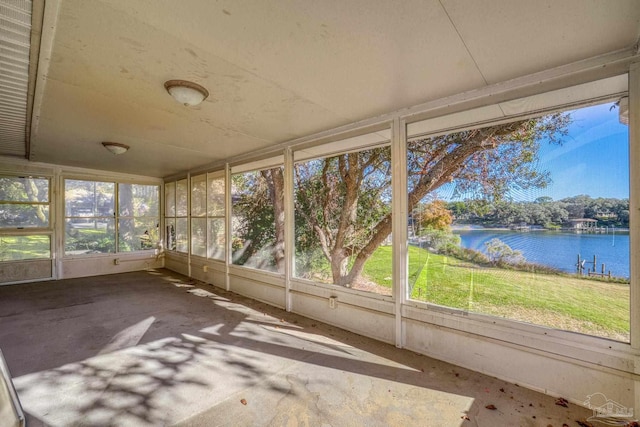 unfurnished sunroom with a water view and a wealth of natural light