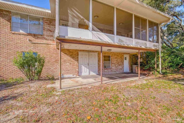 back of house with a patio area and a sunroom