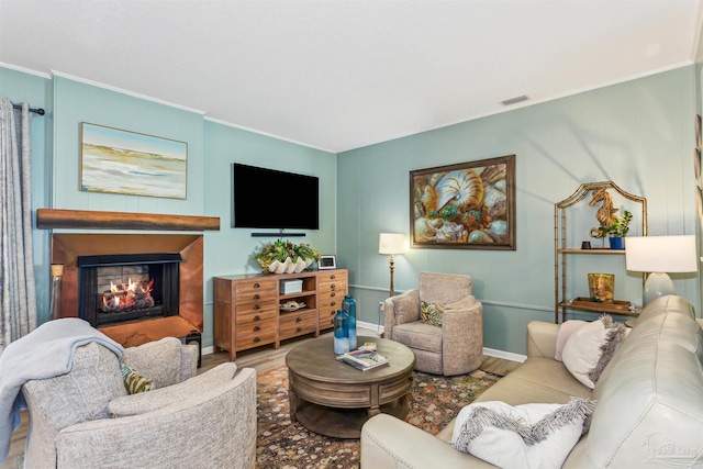 living room with hardwood / wood-style flooring and crown molding