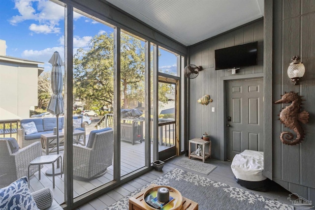 entryway with wood walls and light hardwood / wood-style floors