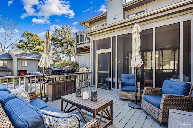 wooden terrace featuring a sunroom and an outdoor living space