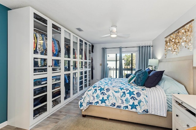 bedroom featuring ceiling fan, access to exterior, and wood-type flooring