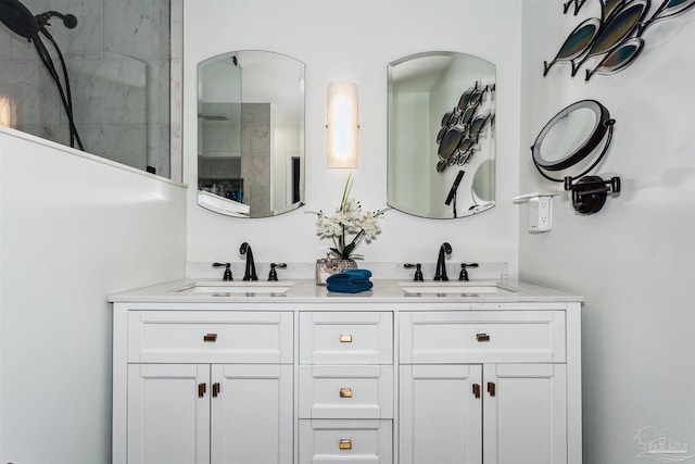 bathroom featuring a shower and vanity