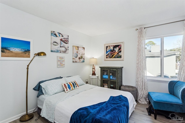 bedroom with wood-type flooring