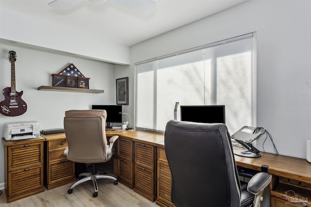 home office featuring light wood-type flooring and ceiling fan