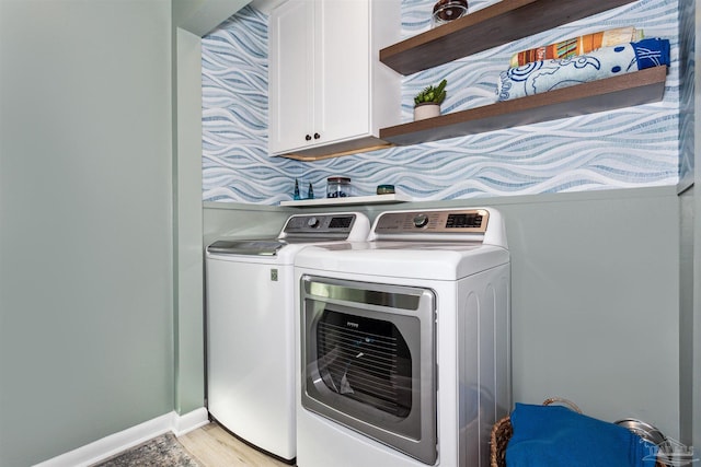 laundry area with cabinets and washing machine and dryer