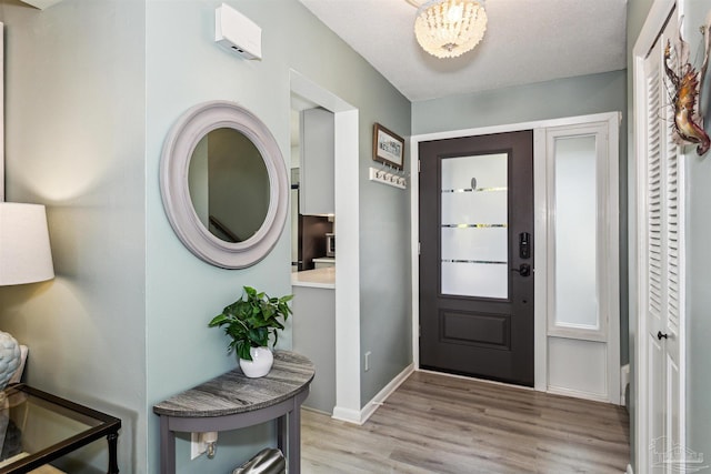 foyer entrance featuring light hardwood / wood-style floors and a textured ceiling