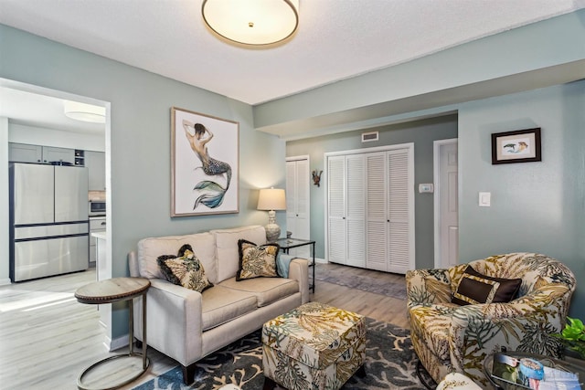 living room with light hardwood / wood-style floors