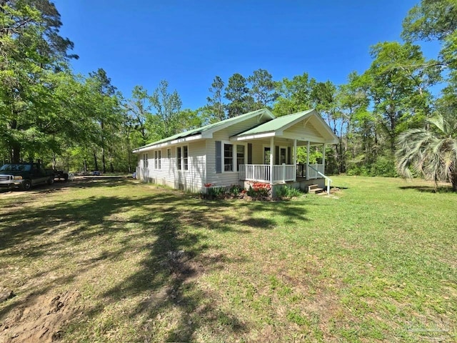 exterior space featuring covered porch and a lawn