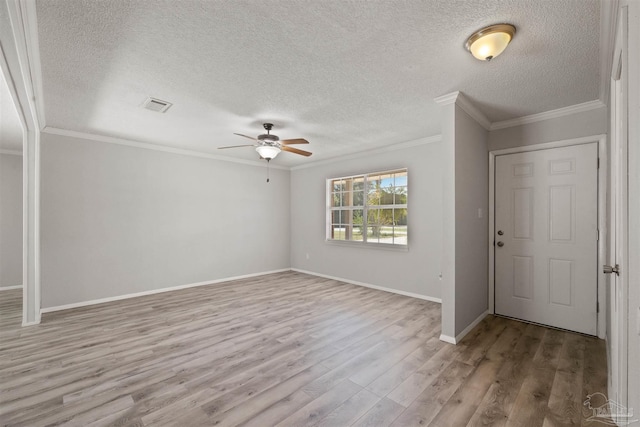 2500 Inda Ave, Pensacola, FL 32526 - entryway with a textured ceiling, visible vents, baseboards, ornamental molding, and light wood-type flooring