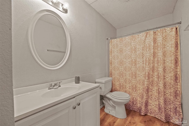 2500 Inda Ave, Pensacola, FL 32526 - full bathroom with a textured ceiling, a textured wall, toilet, wood finished floors, and vanity