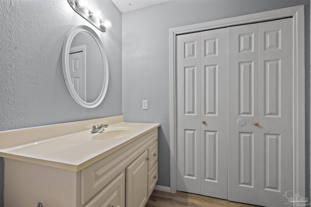 2500 Inda Ave, Pensacola, FL 32526 - bathroom with a textured wall, a closet, wood finished floors, and vanity