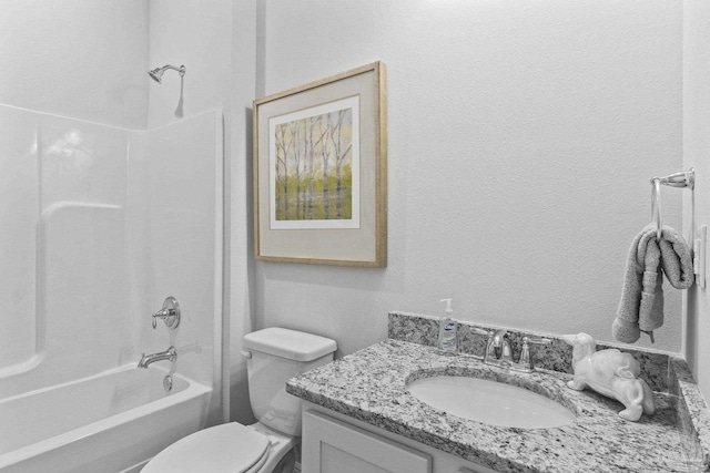 full bathroom featuring washtub / shower combination, vanity, and toilet