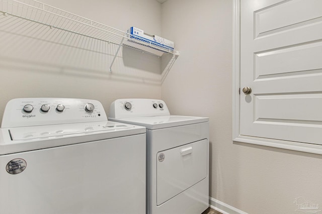 washroom with washing machine and clothes dryer