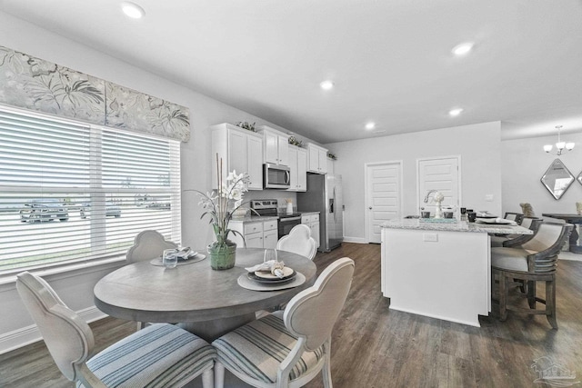 dining space featuring a notable chandelier and dark hardwood / wood-style floors