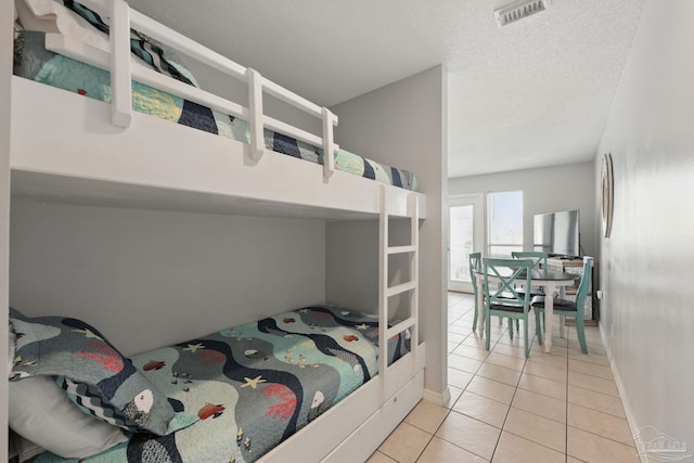 3191 Scenic Highway 98 Unit 212, Destin, FL 32541 - bedroom with light tile patterned floors and a textured ceiling
