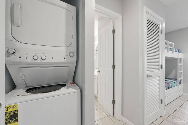 3191 Scenic Highway 98 Unit 212, Destin, FL 32541 - washroom with stacked washer and clothes dryer and light tile patterned flooring