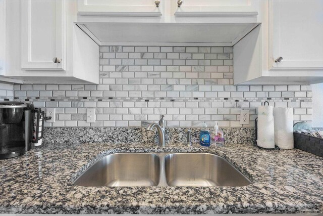 3191 Scenic Highway 98 Unit 212, Destin, FL 32541 - kitchen with white cabinets, backsplash, and dark stone counters
