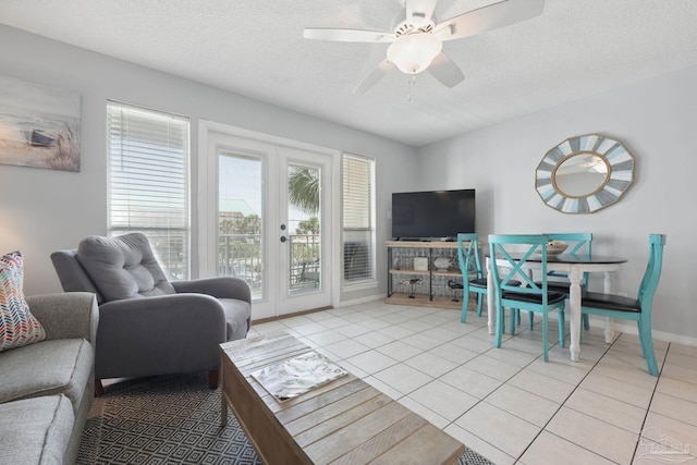 3191 Scenic Highway 98 Unit 212, Destin, FL 32541 - living room with french doors, light tile patterned floors, a ceiling fan, and a textured ceiling