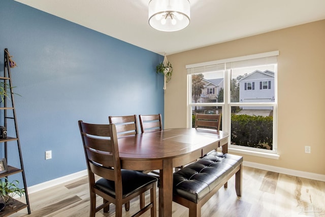 dining room featuring a notable chandelier and light wood-type flooring