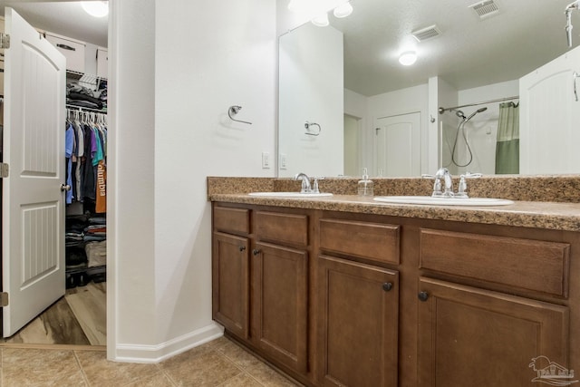 bathroom featuring a shower with curtain, vanity, and tile patterned flooring