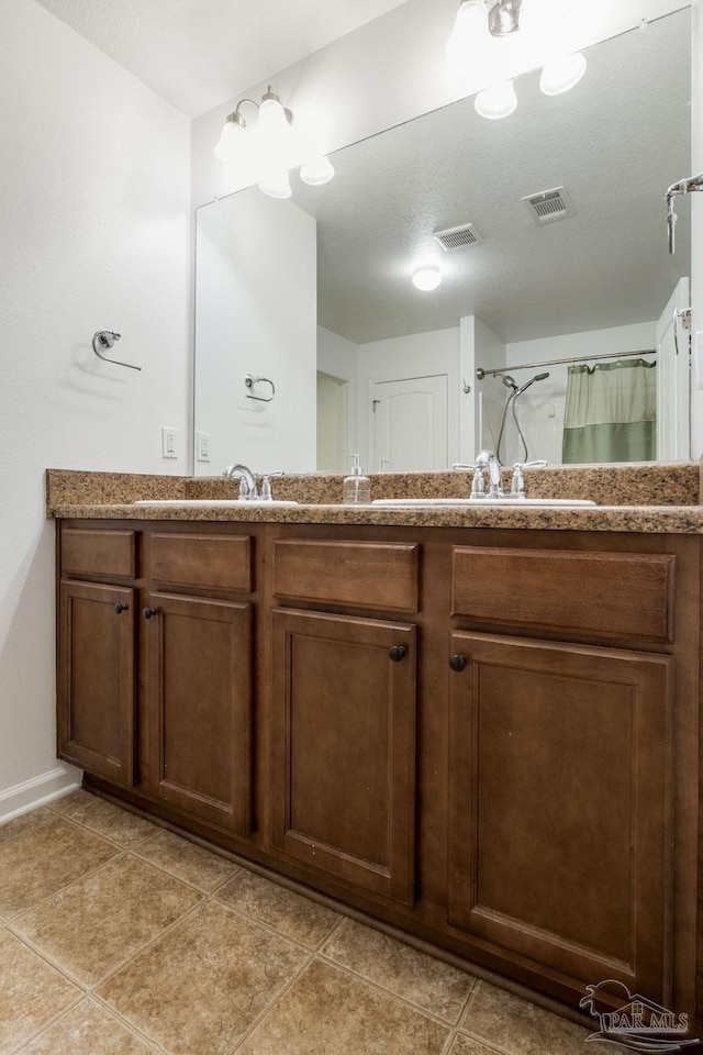 bathroom with tile patterned flooring, vanity, and a shower with curtain