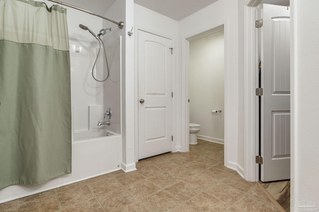 bathroom with tile patterned flooring, shower / bath combination with curtain, and toilet