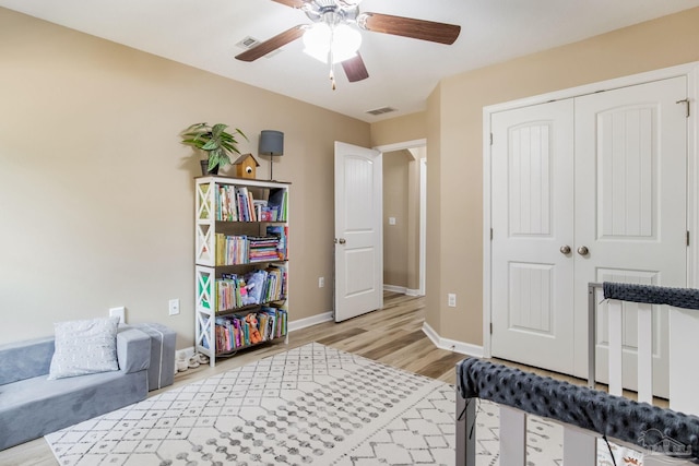 bedroom featuring a closet, ceiling fan, and light hardwood / wood-style flooring