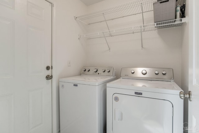 washroom with washing machine and dryer