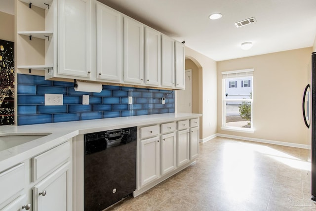 kitchen with tasteful backsplash, white cabinets, dishwasher, and refrigerator