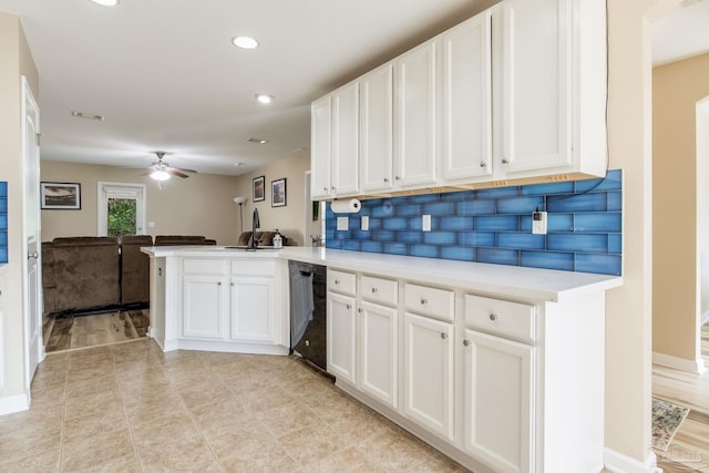 kitchen with black dishwasher, kitchen peninsula, decorative backsplash, and white cabinets