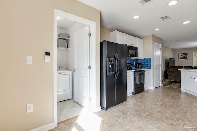 kitchen featuring backsplash, white cabinets, washer / dryer, and black appliances