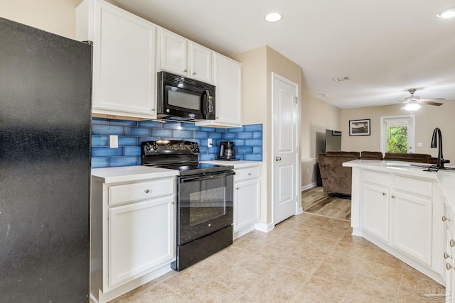 kitchen featuring tasteful backsplash, white cabinets, sink, and black appliances