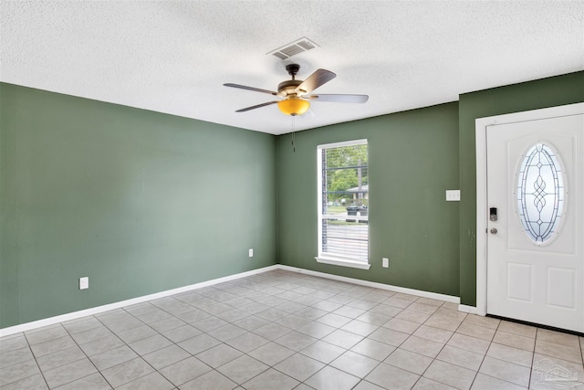913 Bartow Ave, Pensacola, FL 32507 - entryway featuring a textured ceiling, a ceiling fan, baseboards, and light tile patterned flooring