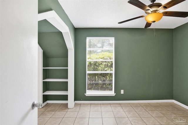 913 Bartow Ave, Pensacola, FL 32507 - unfurnished room featuring ceiling fan, light tile patterned flooring, baseboards, a textured ceiling, and built in shelves