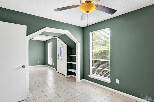 913 Bartow Ave, Pensacola, FL 32507 - unfurnished room with ceiling fan, healthy amount of natural light, light tile patterned flooring, and a textured ceiling