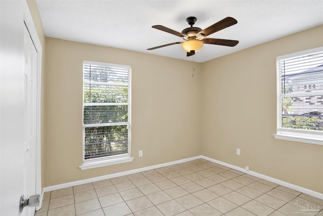 913 Bartow Ave, Pensacola, FL 32507 - empty room with a ceiling fan, light tile patterned floors, baseboards, and a textured ceiling
