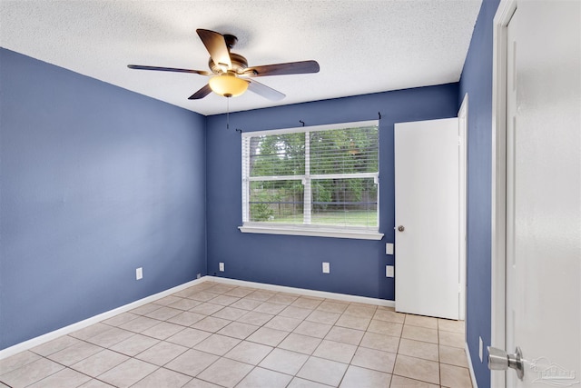 913 Bartow Ave, Pensacola, FL 32507 - empty room featuring a ceiling fan, a textured ceiling, light tile patterned floors, and baseboards