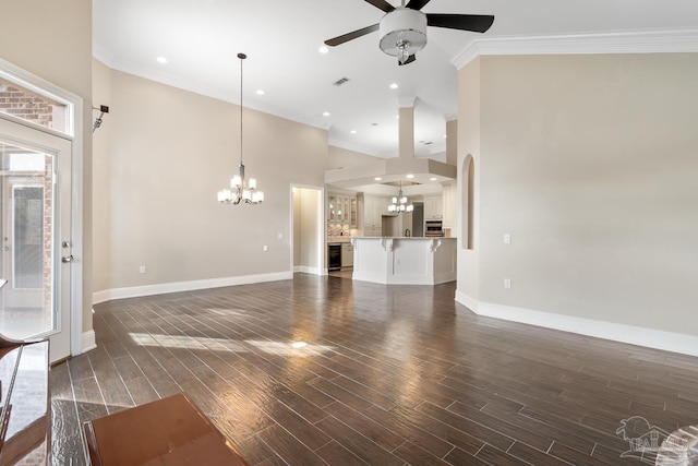 unfurnished living room featuring ceiling fan with notable chandelier and crown molding