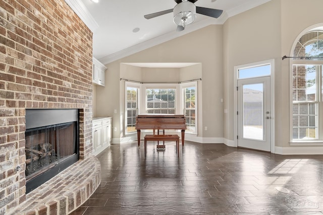 interior space featuring a brick fireplace, dark hardwood / wood-style floors, crown molding, and ceiling fan