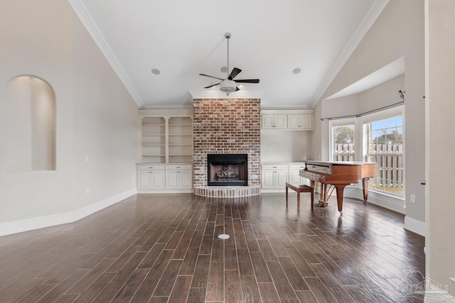 living room with ceiling fan, a fireplace, crown molding, and lofted ceiling