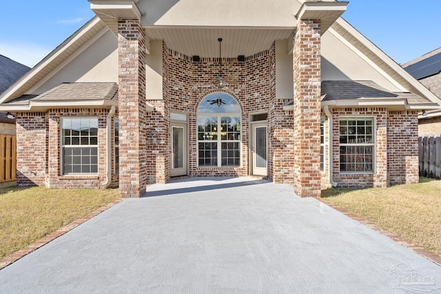 property entrance featuring a lawn