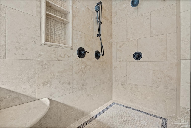 bathroom with tiled shower