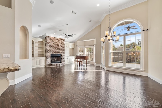 unfurnished living room featuring a fireplace, ornamental molding, high vaulted ceiling, built in shelves, and ceiling fan with notable chandelier